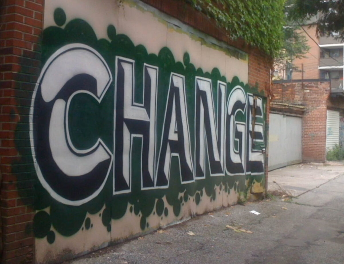 A brick wall painted with the word CHANGE.