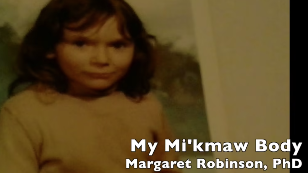 A photograph of a Mi'kmaw child captioned My Mi'kmaw Body, Margaret Robinson, PhD.