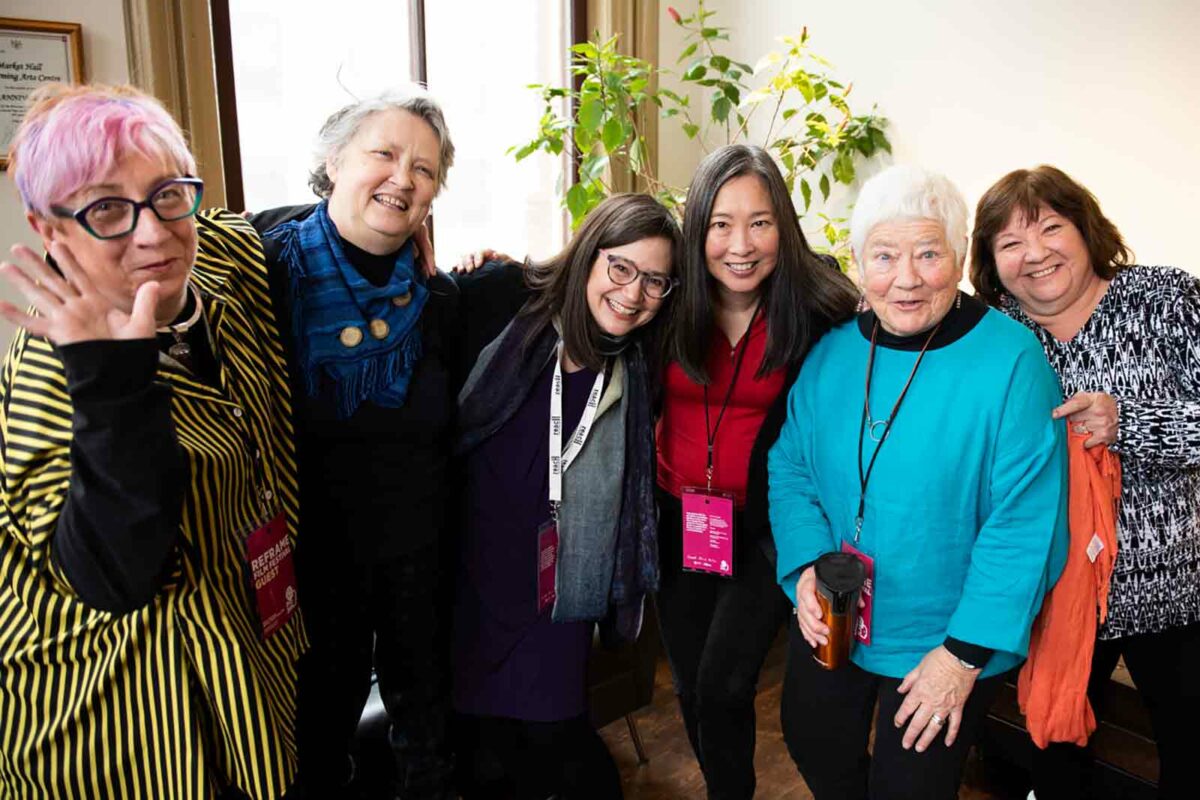 A group of participants at the Aging Vitalities film festival screening pose for a photo.