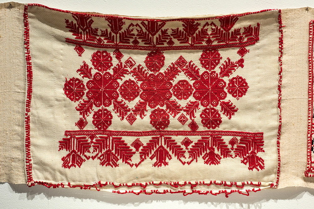 A pattern of red flowers in traditional Hungarian embroidery.