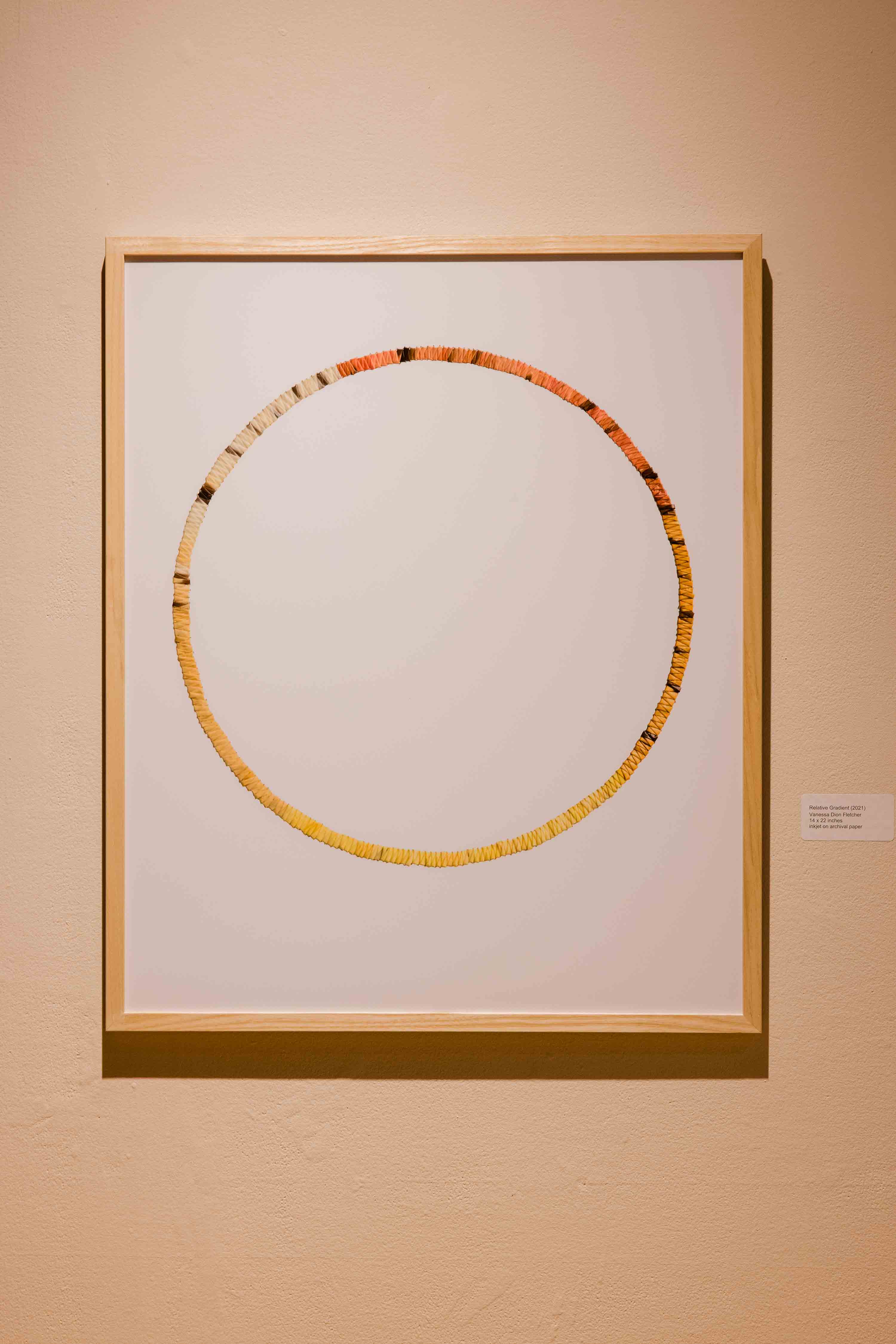 A thin circle woven from dyed porcupine quills.