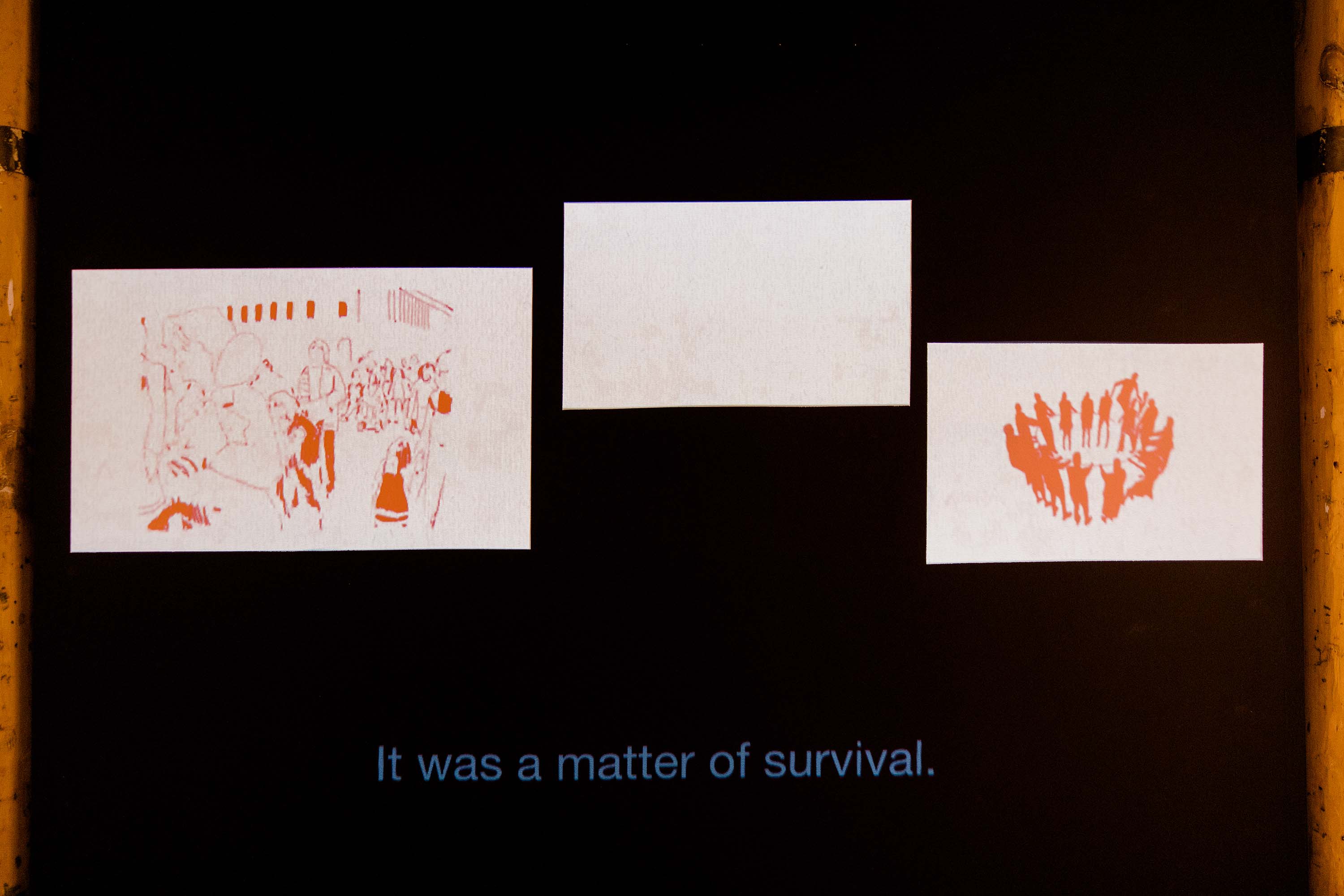 A video still showing two drawings of groups of people.