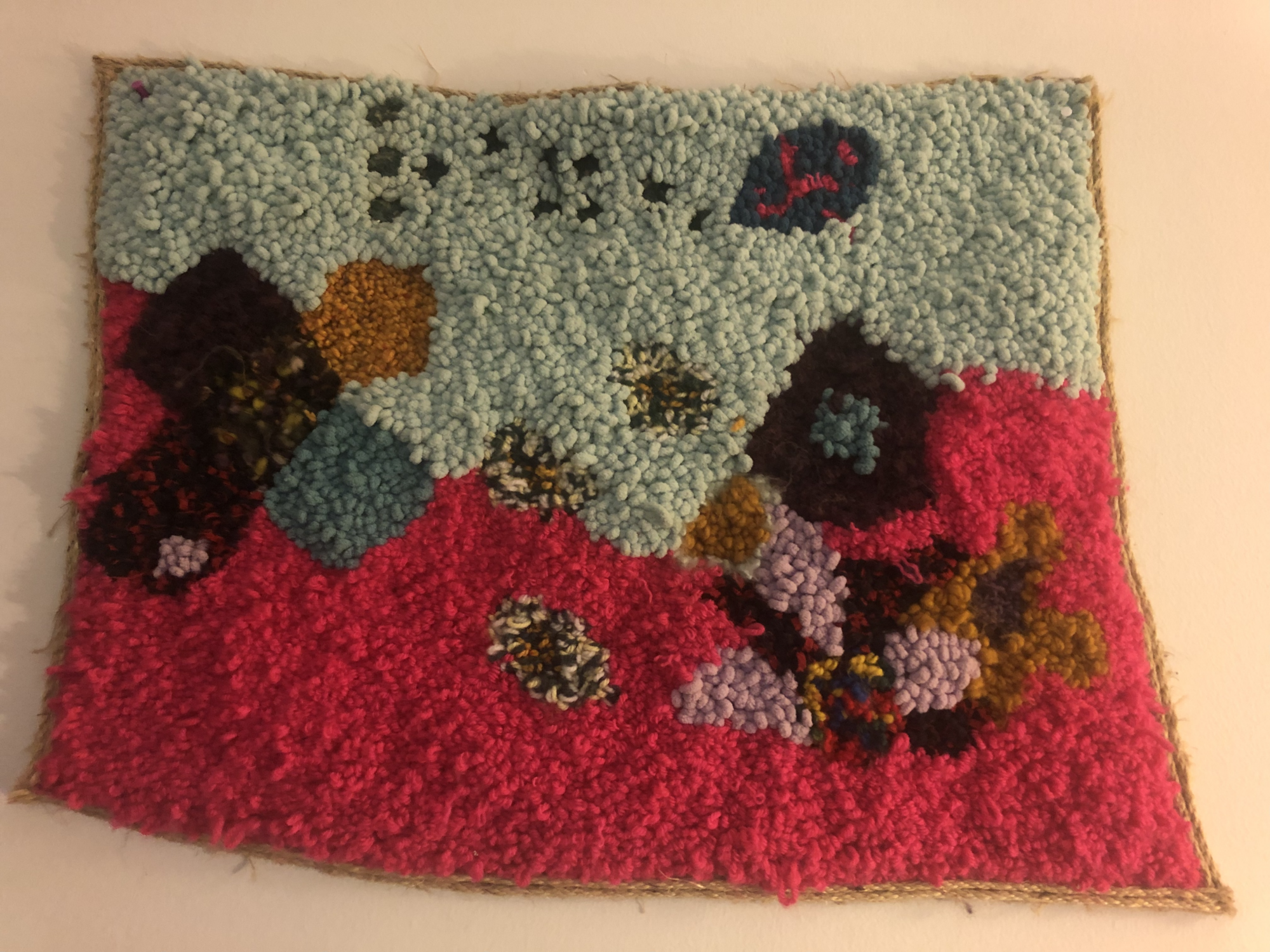 A multicoloured hooked rug.